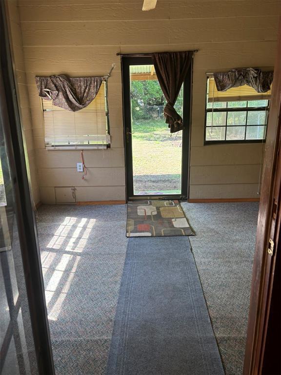 316 N Crenshaw St, Wayne, OK 73080 - doorway to outside featuring carpet flooring and plenty of natural light
