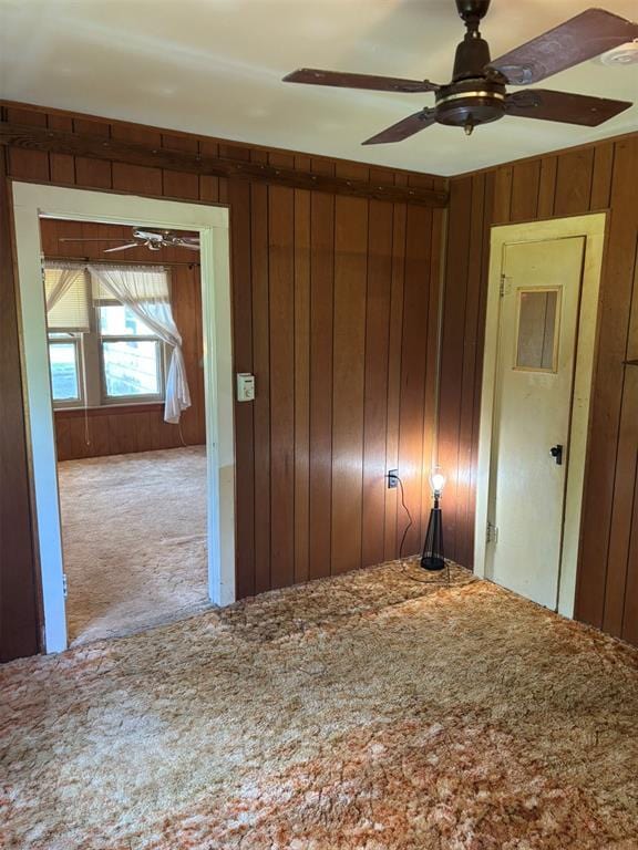 316 N Crenshaw St, Wayne, OK 73080 - unfurnished bedroom with carpet flooring, wood walls, and ceiling fan