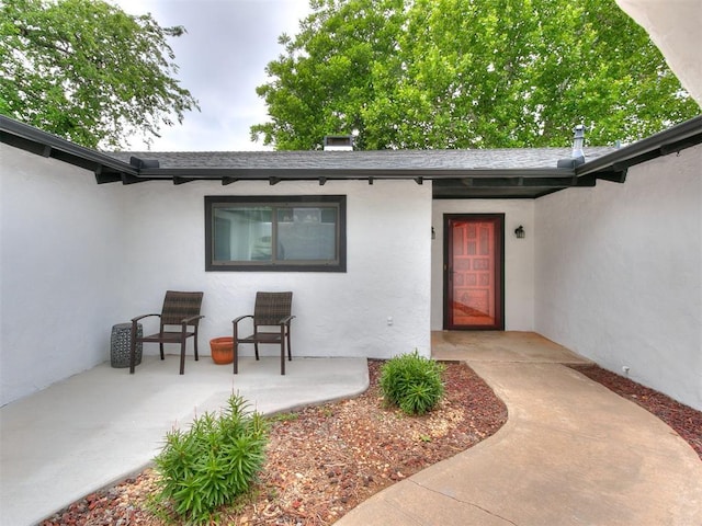 10109 Bison Cir, Yukon, OK 73099 - entrance to property with stucco siding and a patio area
