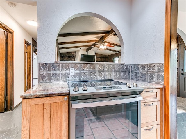 10109 Bison Cir, Yukon, OK 73099 - kitchen featuring stainless steel range with electric cooktop, a ceiling fan, arched walkways, a textured wall, and stone counters