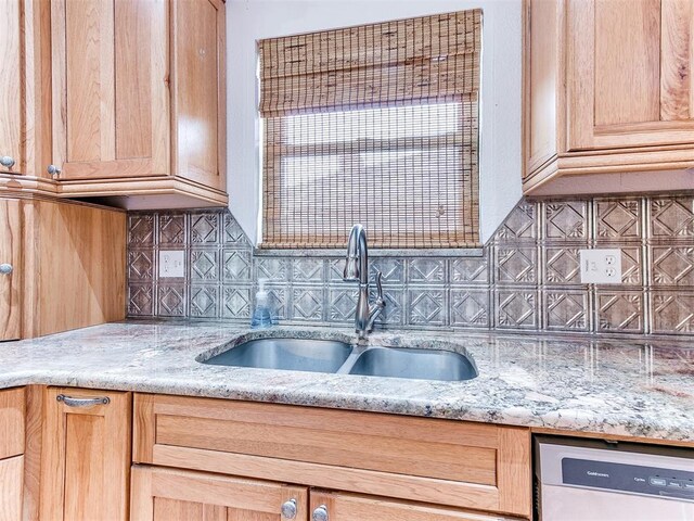 10109 Bison Cir, Yukon, OK 73099 - kitchen featuring dishwashing machine, a sink, backsplash, light stone counters, and light brown cabinets