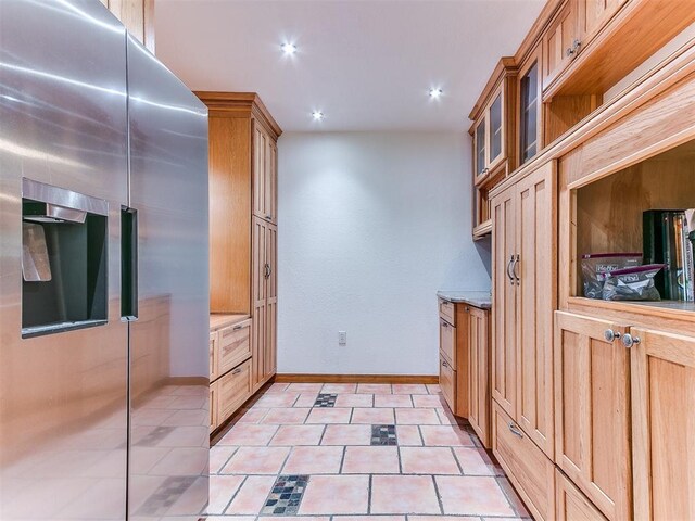 10109 Bison Cir, Yukon, OK 73099 - kitchen with stainless steel refrigerator with ice dispenser, glass insert cabinets, baseboards, light tile patterned flooring, and recessed lighting