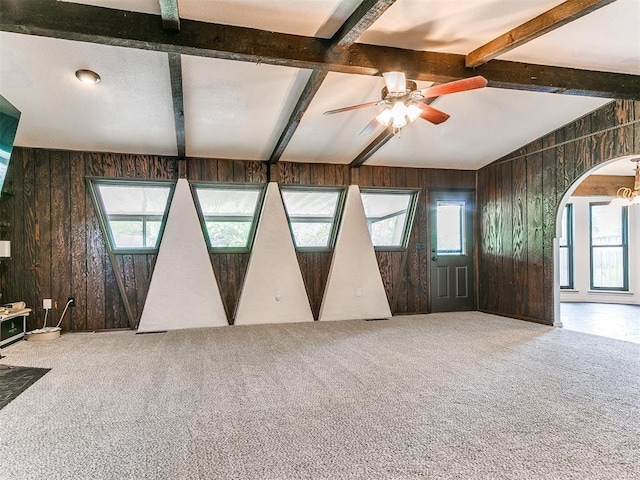 10109 Bison Cir, Yukon, OK 73099 - carpeted empty room with wood walls, a ceiling fan, and arched walkways