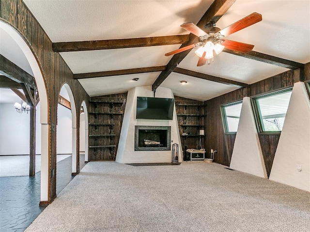 10109 Bison Cir, Yukon, OK 73099 - unfurnished living room with a fireplace with flush hearth, built in shelves, a ceiling fan, and arched walkways
