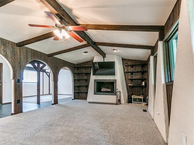 10109 Bison Cir, Yukon, OK 73099 - unfurnished living room with a fireplace with flush hearth, built in features, a ceiling fan, and carpet flooring