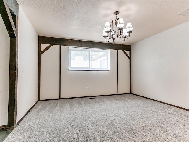 10109 Bison Cir, Yukon, OK 73099 - carpeted empty room with a chandelier, a textured ceiling, and baseboards