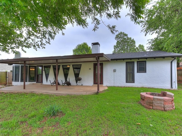 10109 Bison Cir, Yukon, OK 73099 - rear view of property with a fire pit, a patio, stucco siding, and a chimney