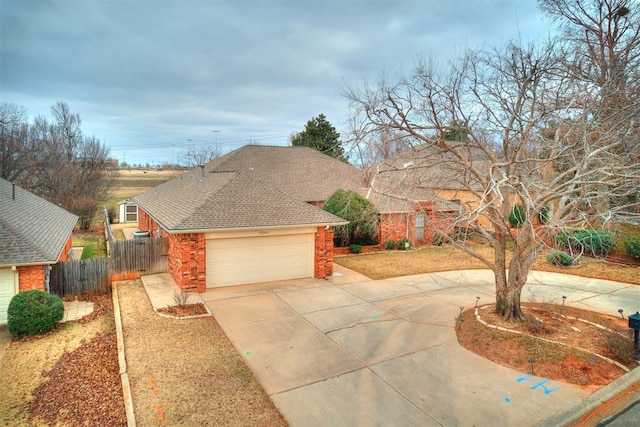 12104 Cantle Rd, Oklahoma City, OK 73120 - view of front facade featuring concrete driveway, a garage, roof with shingles, and stone siding