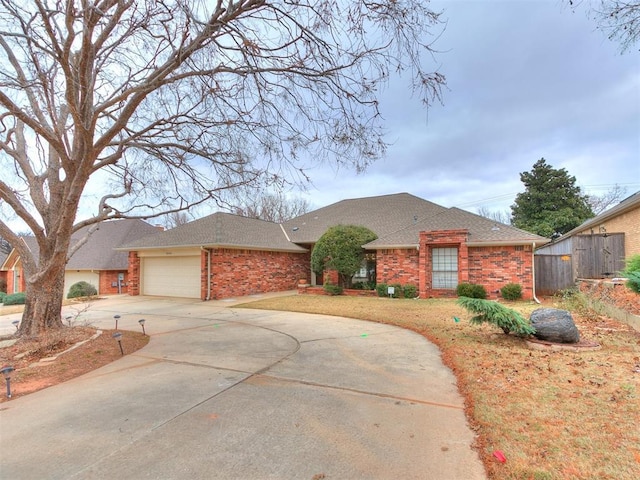 12104 Cantle Rd, Oklahoma City, OK 73120 - ranch-style house featuring brick siding, roof with shingles, driveway, and an attached garage