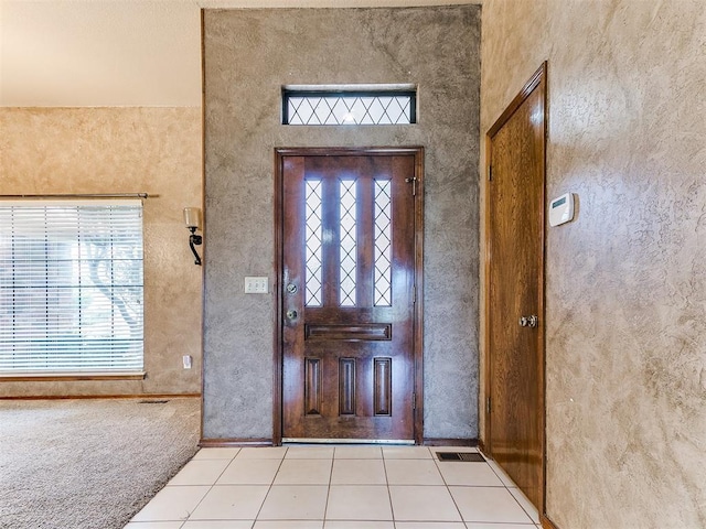 12104 Cantle Rd, Oklahoma City, OK 73120 - foyer with light tile patterned floors and a textured wall