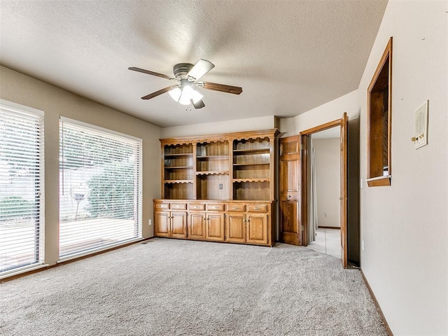 12104 Cantle Rd, Oklahoma City, OK 73120 - spare room featuring light colored carpet, a ceiling fan, and a textured ceiling