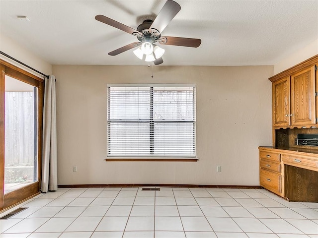 12104 Cantle Rd, Oklahoma City, OK 73120 - kitchen featuring healthy amount of natural light, brown cabinetry, and a ceiling fan