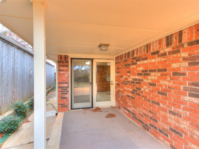 12104 Cantle Rd, Oklahoma City, OK 73120 - doorway to property with a patio and brick siding