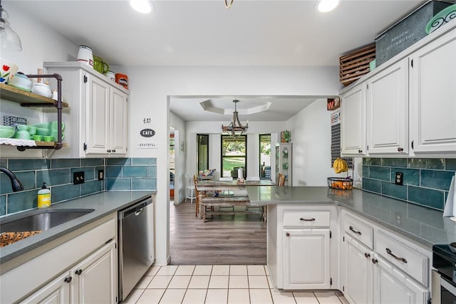 11110 Jeffords Ave, Choctaw, OK 73020 - kitchen with stainless steel dishwasher, open shelves, a peninsula, white cabinets, and light tile patterned floors