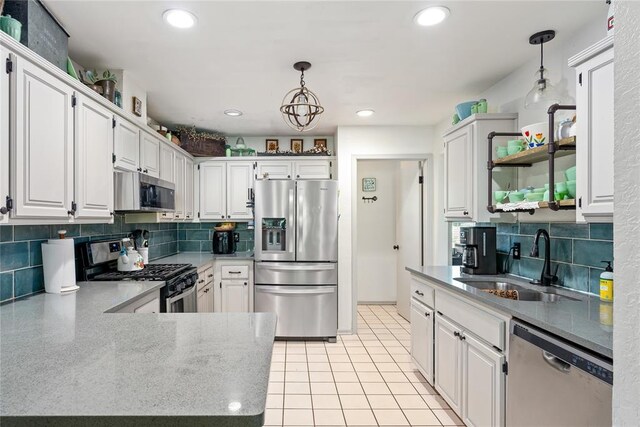 11110 Jeffords Ave, Choctaw, OK 73020 - kitchen featuring appliances with stainless steel finishes, a sink, open shelves, decorative backsplash, and hanging light fixtures
