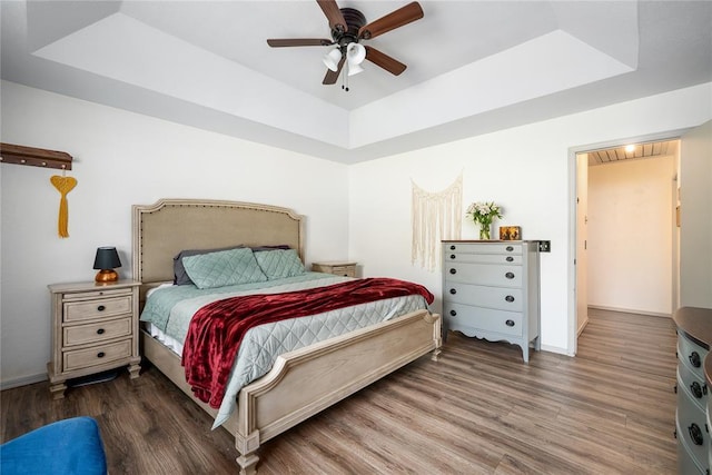 11110 Jeffords Ave, Choctaw, OK 73020 - bedroom featuring a raised ceiling, wood finished floors, baseboards, and ceiling fan