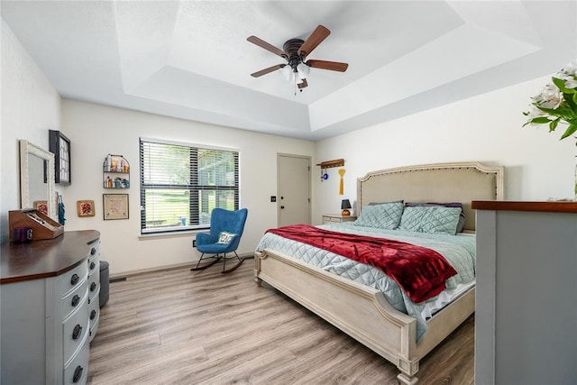 11110 Jeffords Ave, Choctaw, OK 73020 - bedroom with a raised ceiling, light wood-type flooring, baseboards, and ceiling fan