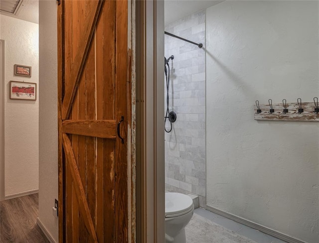11110 Jeffords Ave, Choctaw, OK 73020 - full bath featuring a tile shower, a textured wall, and wood finished floors
