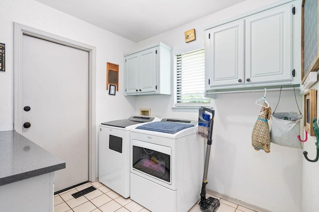 11110 Jeffords Ave, Choctaw, OK 73020 - laundry area featuring cabinet space, independent washer and dryer, and light tile patterned floors