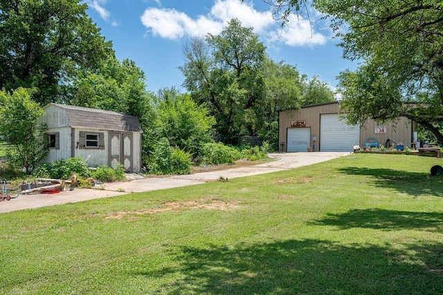 11110 Jeffords Ave, Choctaw, OK 73020 - view of grassy yard featuring an outdoor structure and a detached garage
