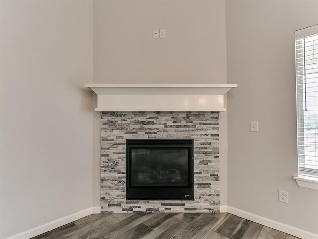 3909 Palisade Ln, Oklahoma City, OK 73179 - detailed view of wood finished floors, baseboards, and a glass covered fireplace