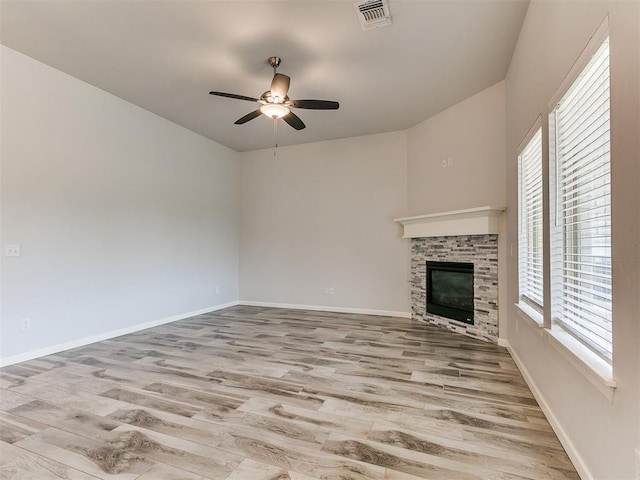 3909 Palisade Ln, Oklahoma City, OK 73179 - unfurnished living room with healthy amount of natural light, a ceiling fan, a glass covered fireplace, and wood finished floors