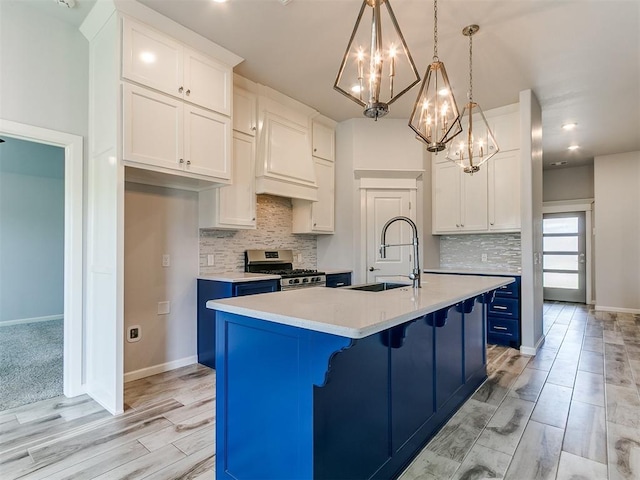 3909 Palisade Ln, Oklahoma City, OK 73179 - kitchen with gas stove, a sink, a chandelier, blue cabinets, and light countertops