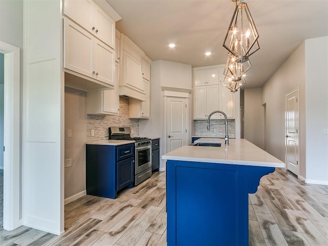 3909 Palisade Ln, Oklahoma City, OK 73179 - kitchen featuring stainless steel gas stove, a sink, light wood-style floors, light countertops, and backsplash