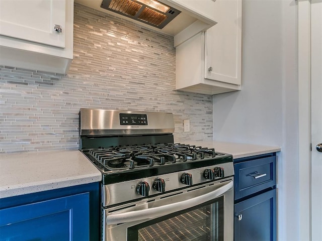 3909 Palisade Ln, Oklahoma City, OK 73179 - kitchen featuring stainless steel range with gas cooktop, tasteful backsplash, premium range hood, and blue cabinets