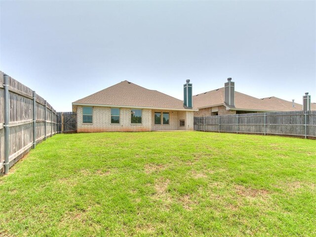 3909 Palisade Ln, Oklahoma City, OK 73179 - rear view of house with brick siding