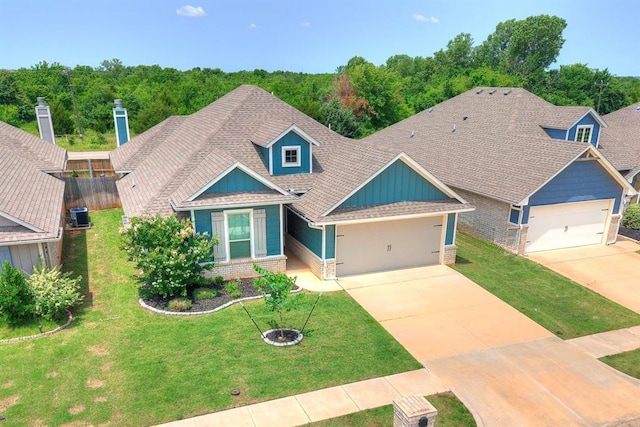 3909 Palisade Ln, Oklahoma City, OK 73179 - view of front of property featuring a garage, concrete driveway, cooling unit, and brick siding
