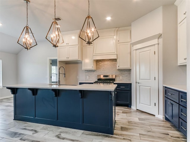 3909 Palisade Ln, Oklahoma City, OK 73179 - kitchen featuring custom exhaust hood, stainless steel stove, decorative backsplash, light countertops, and white cabinets