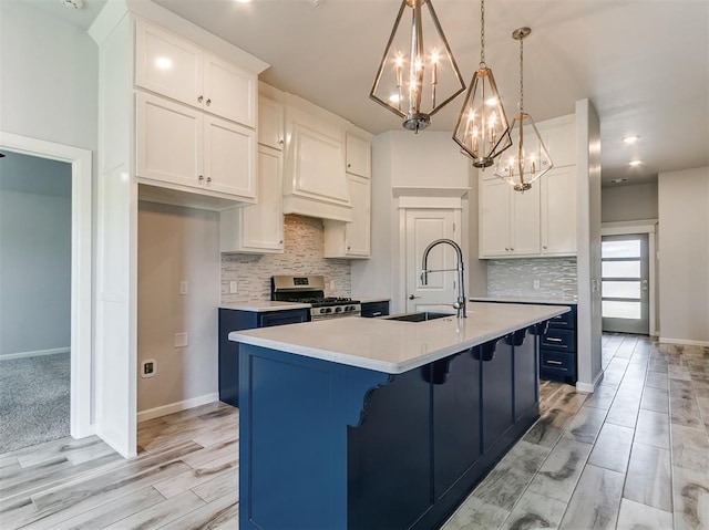3909 Palisade Ln, Oklahoma City, OK 73179 - kitchen featuring gas range, a chandelier, light countertops, decorative backsplash, and light wood-style floors