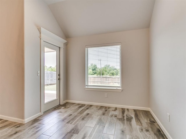 3909 Palisade Ln, Oklahoma City, OK 73179 - spare room featuring healthy amount of natural light, light wood finished floors, and lofted ceiling