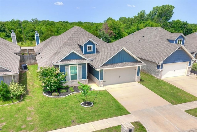 3909 Palisade Ln, Oklahoma City, OK 73179 - craftsman house with an attached garage, concrete driveway, brick siding, and a shingled roof