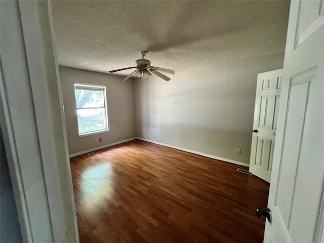74 Fox Run Cir, Jenks, OK 74037 - empty room featuring wood finished floors, a ceiling fan, a textured ceiling, and baseboards