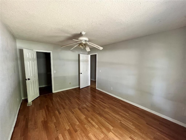74 Fox Run Cir, Jenks, OK 74037 - unfurnished bedroom with wood finished floors, a textured ceiling, baseboards, and a ceiling fan