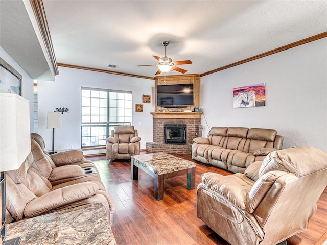 7705 Dripping Springs Ln, Oklahoma City, OK 73150 - living area with a ceiling fan, wood finished floors, ornamental molding, and a fireplace