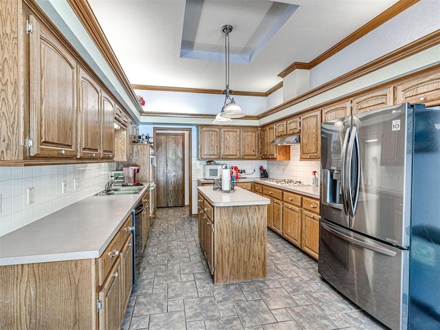 7705 Dripping Springs Ln, Oklahoma City, OK 73150 - kitchen featuring stainless steel fridge, a tray ceiling, white microwave, tasteful backsplash, and a center island
