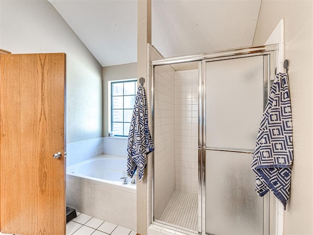 7705 Dripping Springs Ln, Oklahoma City, OK 73150 - bathroom featuring a garden tub, a stall shower, vaulted ceiling, and tile patterned flooring