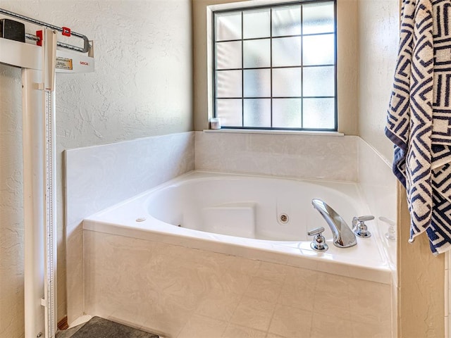 7705 Dripping Springs Ln, Oklahoma City, OK 73150 - full bathroom with a textured wall and a tub with jets