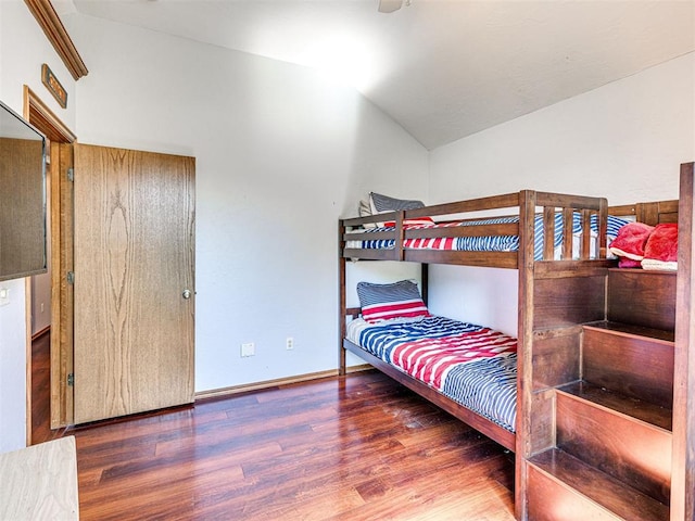 7705 Dripping Springs Ln, Oklahoma City, OK 73150 - bedroom with wood finished floors and lofted ceiling