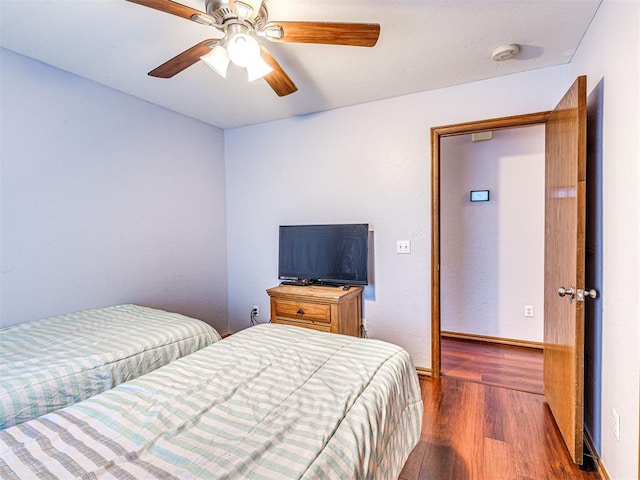 7705 Dripping Springs Ln, Oklahoma City, OK 73150 - bedroom featuring dark wood-type flooring and a ceiling fan