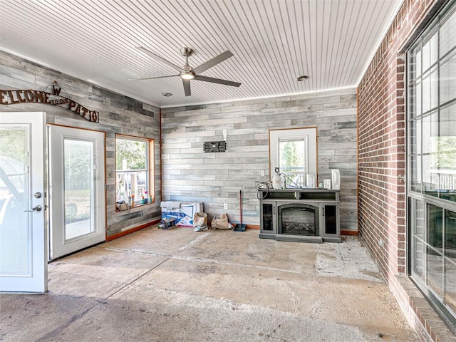 7705 Dripping Springs Ln, Oklahoma City, OK 73150 - unfurnished living room featuring a ceiling fan and a fireplace