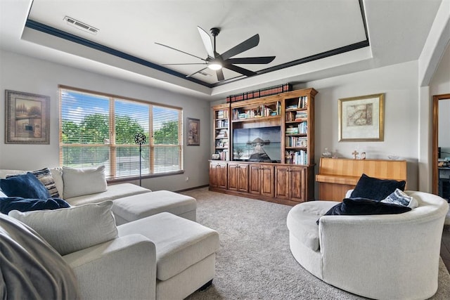 2528 E Bradley St, Shawnee, OK 74804 - living room featuring a tray ceiling, a ceiling fan, carpet floors, and baseboards