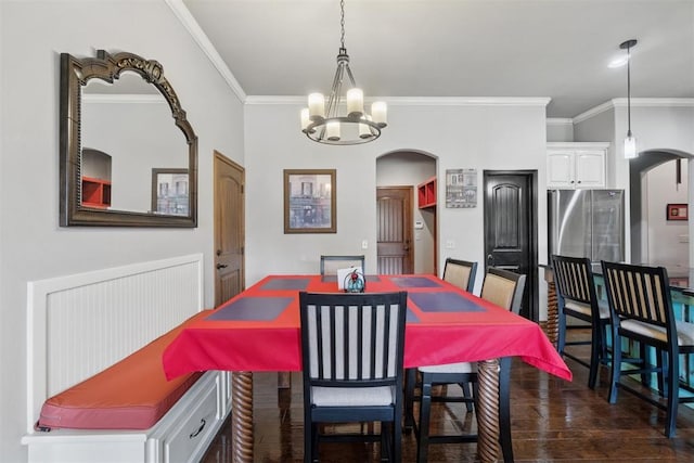 2528 E Bradley St, Shawnee, OK 74804 - dining room featuring arched walkways, ornamental molding, a chandelier, and dark wood-style floors
