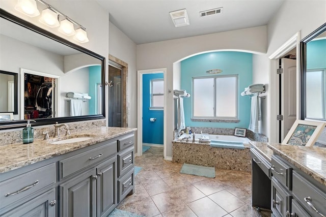 2528 E Bradley St, Shawnee, OK 74804 - full bath featuring vanity, a bath, tile patterned flooring, and a walk in closet
