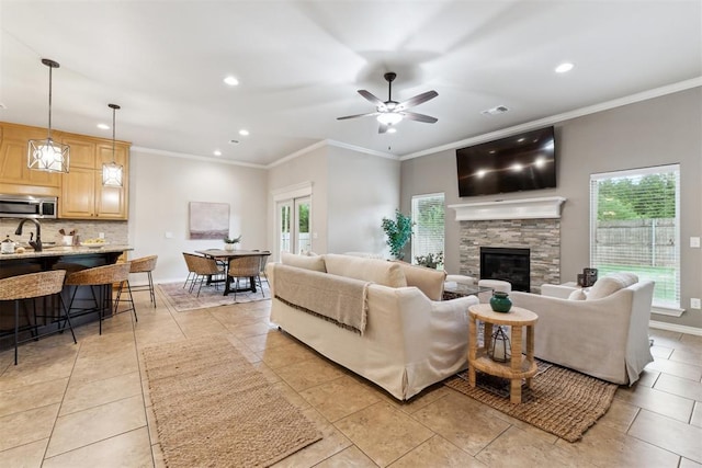 4932 Mahogany Dr, Edmond, OK 73025 - living area with recessed lighting, ceiling fan, light tile patterned floors, crown molding, and a fireplace