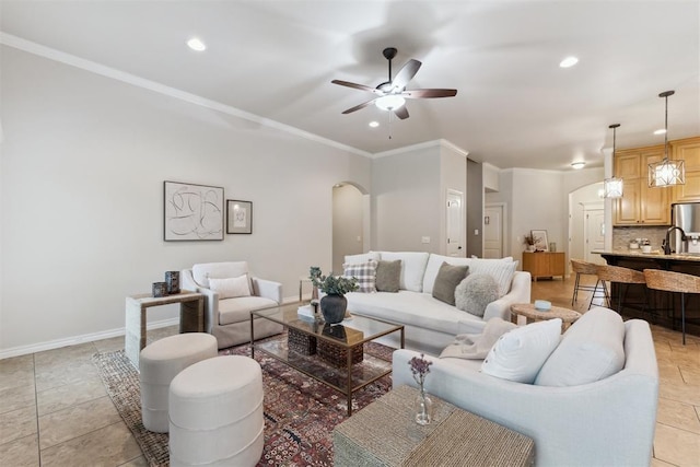 4932 Mahogany Dr, Edmond, OK 73025 - living room featuring arched walkways, ceiling fan, recessed lighting, ornamental molding, and baseboards