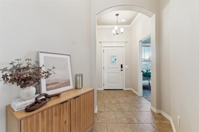 4932 Mahogany Dr, Edmond, OK 73025 - foyer featuring arched walkways, crown molding, baseboards, and light tile patterned flooring